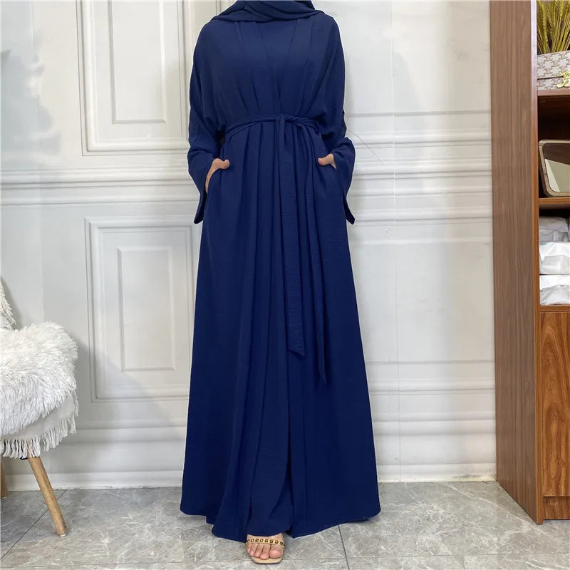 A full-length navy blue elegant women's abaya and kaftan set displayed indoors.