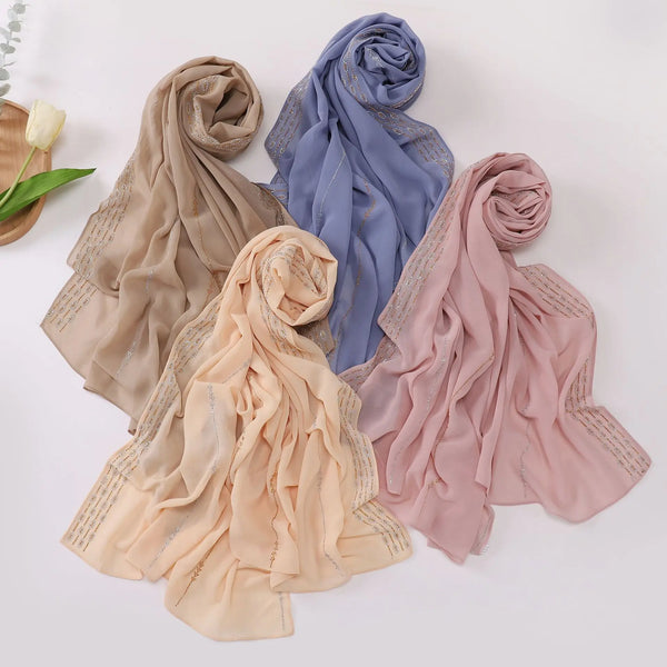 Four rolled chiffon scarves in beige, blue, and pink tones displayed on a white background