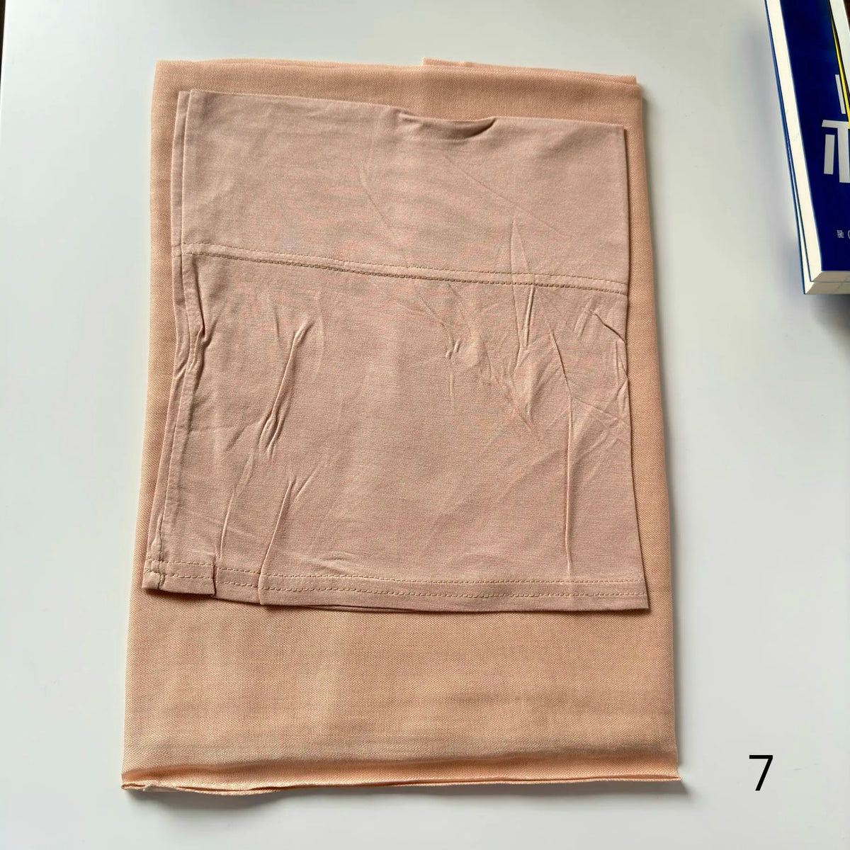 A light beige soft modal rayon hijab set folded flat on a white surface.