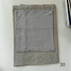 A folded light gray soft modal rayon hijab set for women displayed on a white surface.