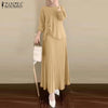 Une femme modélise une longue robe maxi beige à manches longues avec jupe plissée et un hijab assorti.
