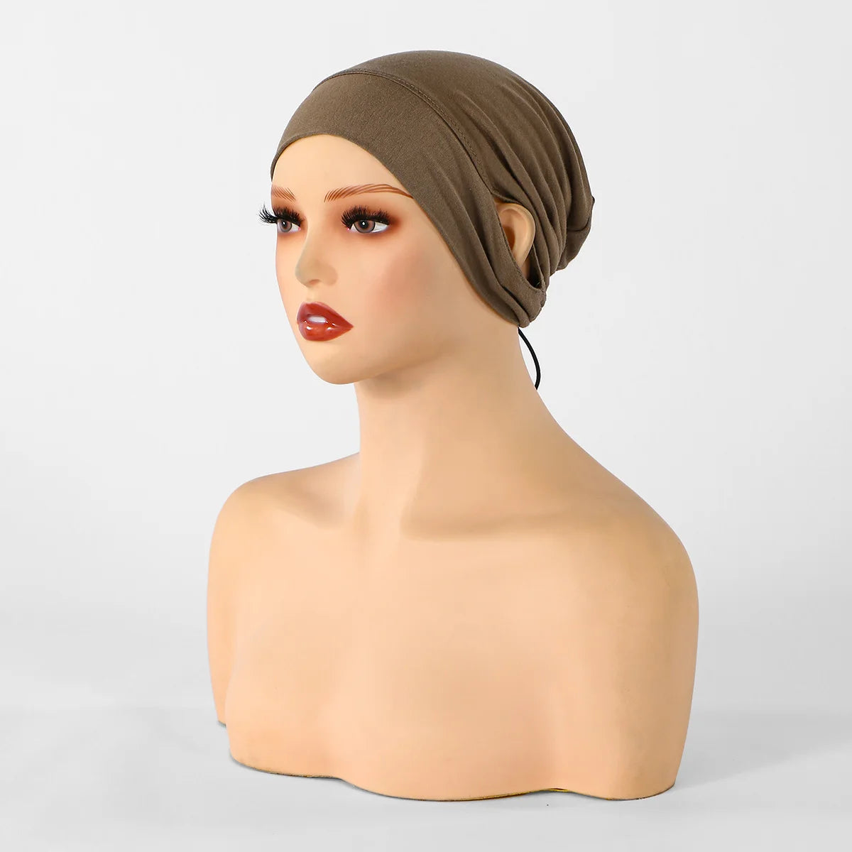 Mannequin's head wearing a brown jersey cotton hijab cap for women.