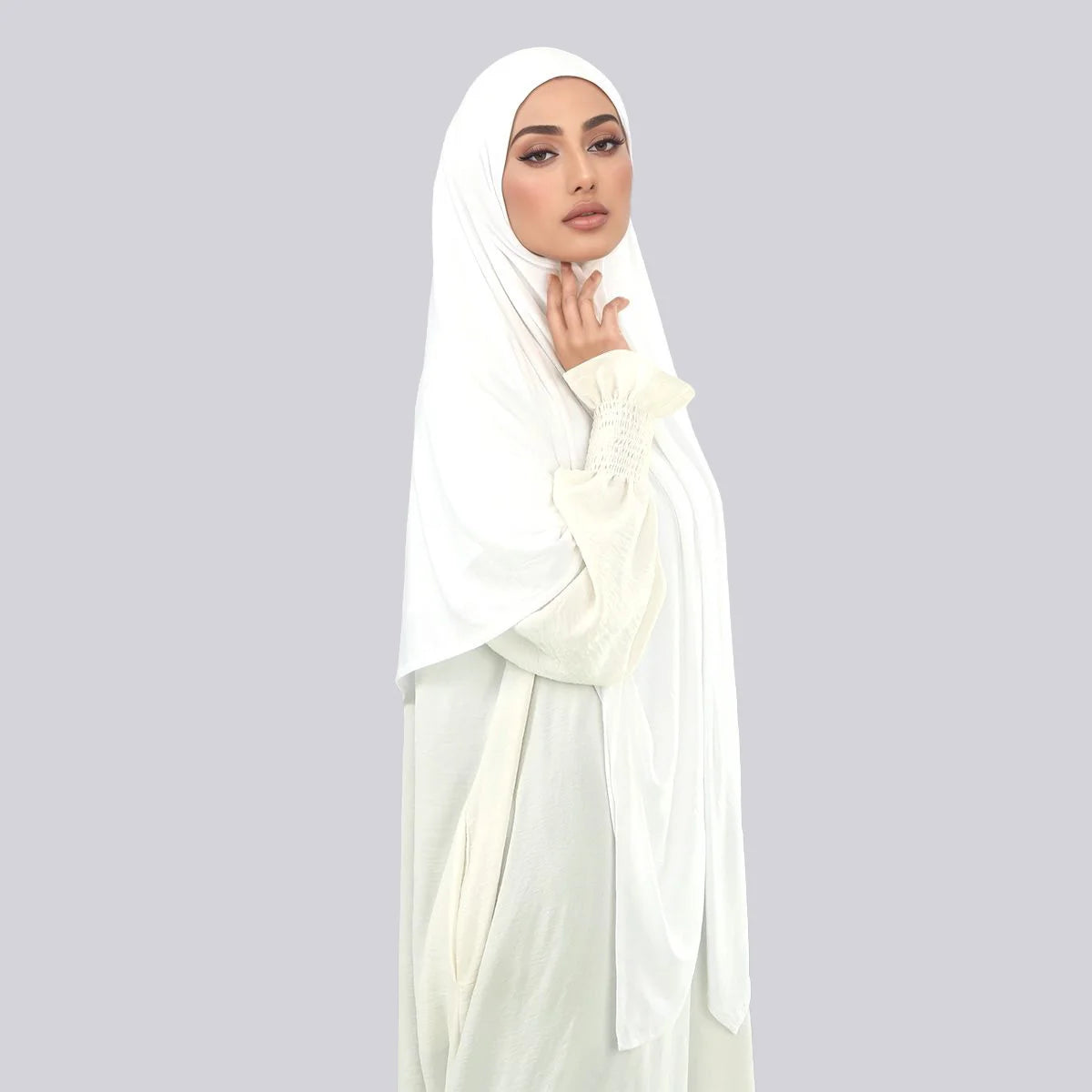 A woman wearing a white large size stretchy modal square scarf for Islamic wear.