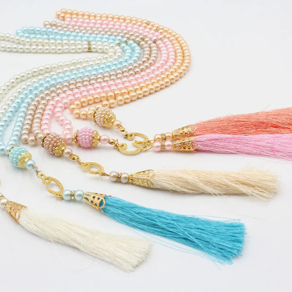 A collection of nine bead prayer rosary bracelets in shades of pink, peach, and blue.