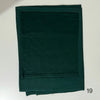 A dark emerald green soft modal rayon hijab set folded flat.
