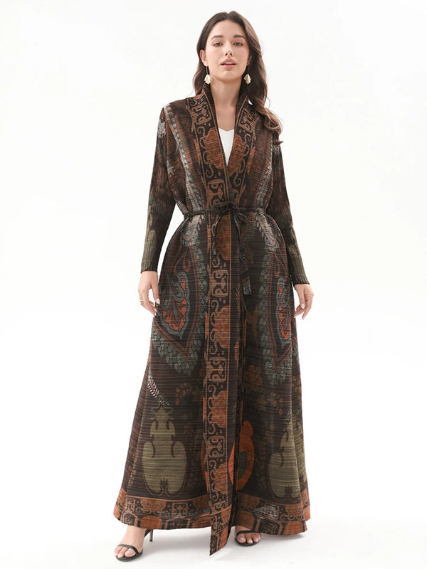 A woman models a long, dark brown vintage printed dress with a turn-down collar and a self-tie belt.