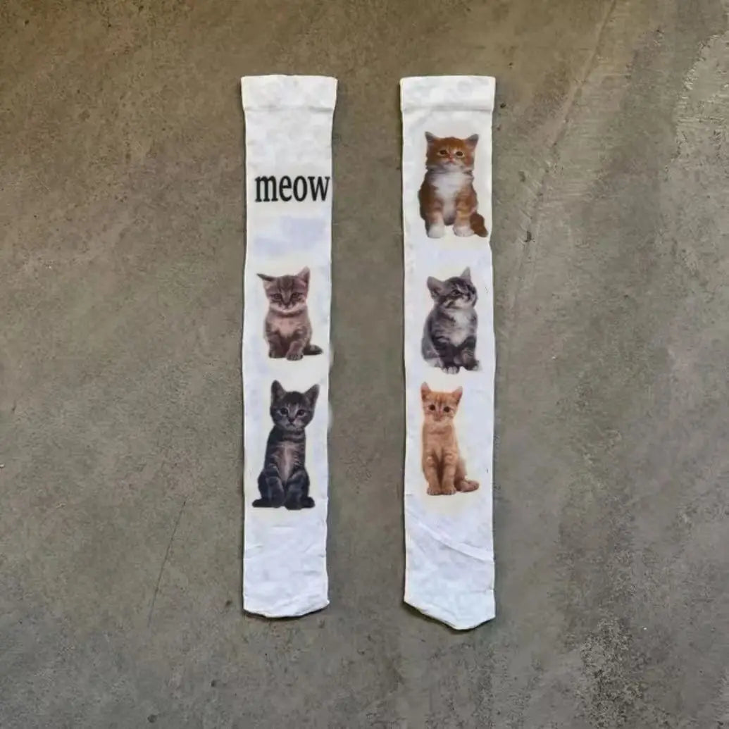 Weiße Socken mit einer schwarzen Katzenillustration und dem Wort Miauen