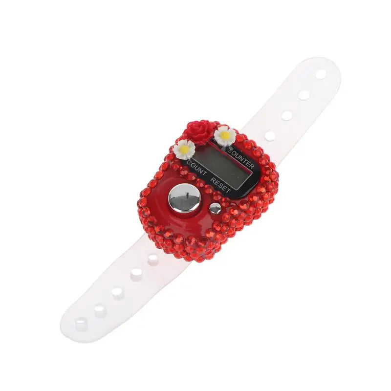 A red finger counter with a digital display and white strap for meditation and counting.