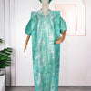 A woman wearing a teal satin kaftan abaya with a matching headscarf displayed on a mannequin.