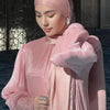 Une femme portant un foulard hijab en mousseline crinkle rose pâle et scintillant
