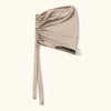 A beige anti-slip inner hijab cap with gathered fabric and a black trim.