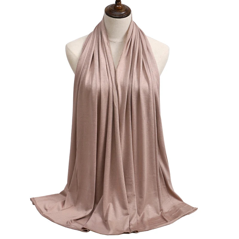 A draped, flowing mauve modal jersey hijab displayed on a mannequin.