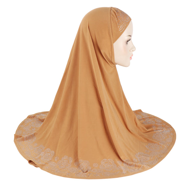 A woman wearing a terracotta colored floral rhinestone scarf hijab