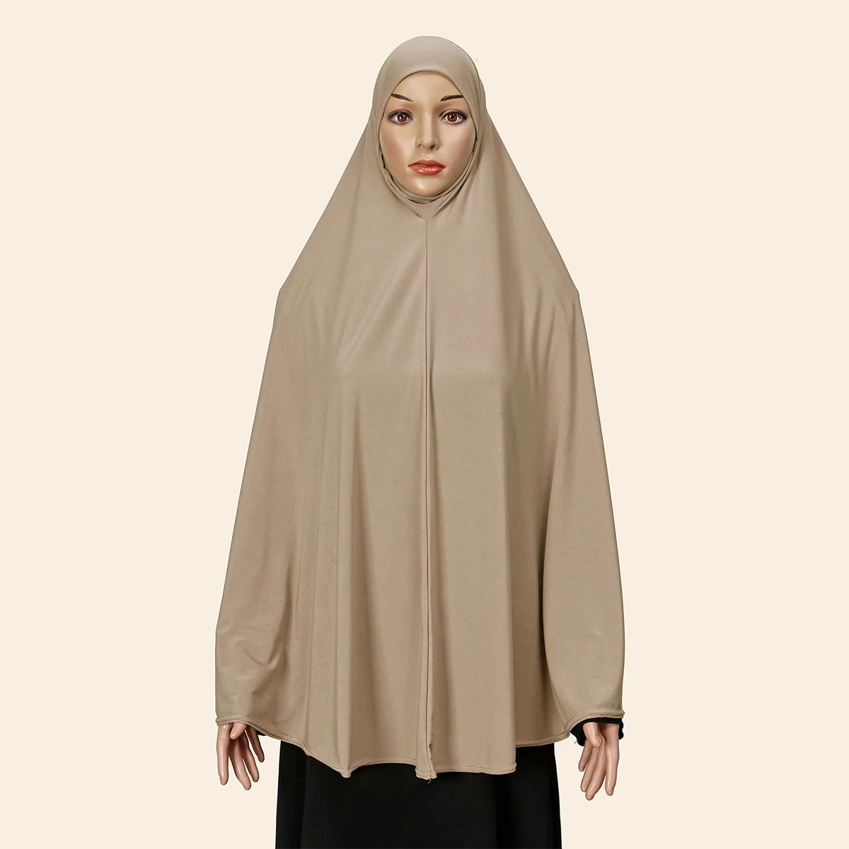 Model wearing a beige full-cover abaya with an inner hijab.