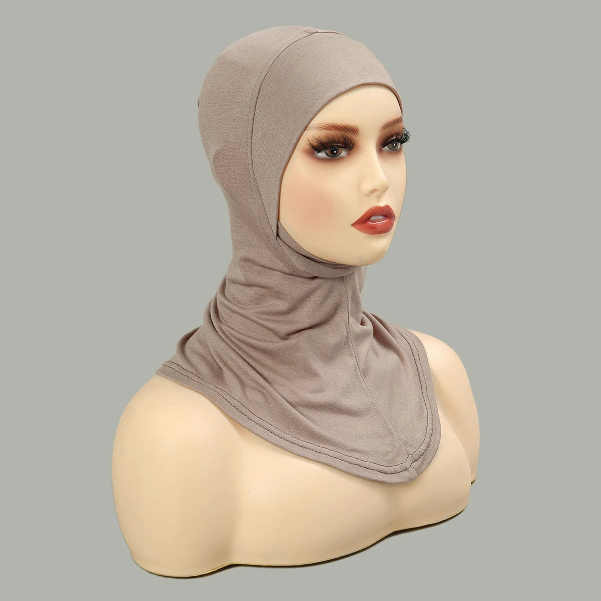 Model wearing a beige, stretchy cotton, full coverage hijab bonnet.