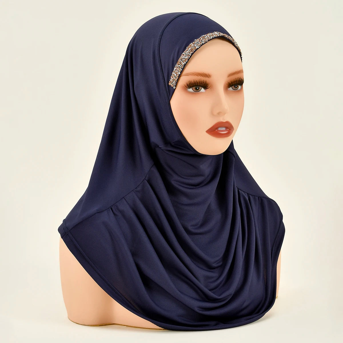 Model trägt einen marineblauen Instant-Hijab mit goldbesetztem Stirnband.