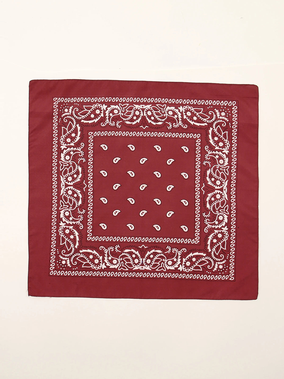 Tissu rouge carré avec broderie paisley blanche et motifs géométriques.