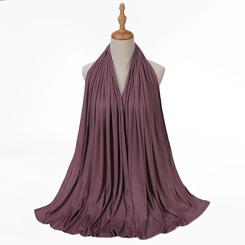A mauve ribbed jersey hijab scarf draped around a mannequin neck.