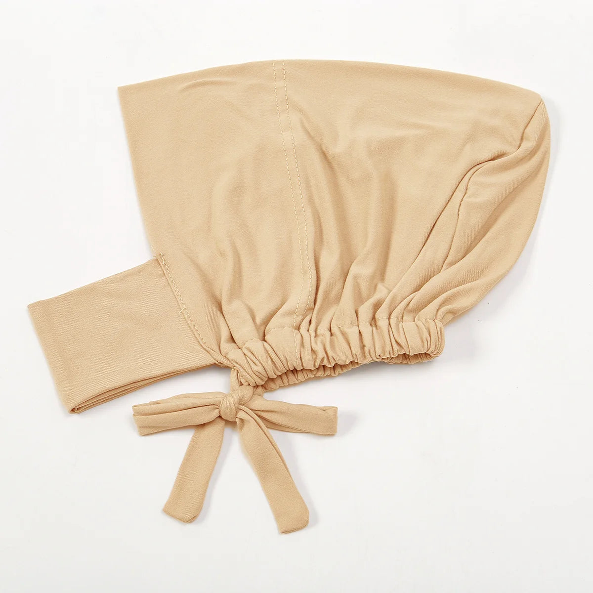 A beige cotton polyester inner hijab cap scarf tied at the bottom with a bow.