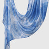 A light blue printed linen hijab scarf draped elegantly.