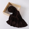 A dark brown ribbed jersey hijab scarf is displayed inside a light wooden frame.