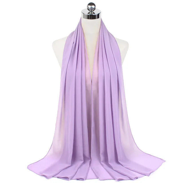 A lilac chiffon hijab scarf draped around a mannequin neck.