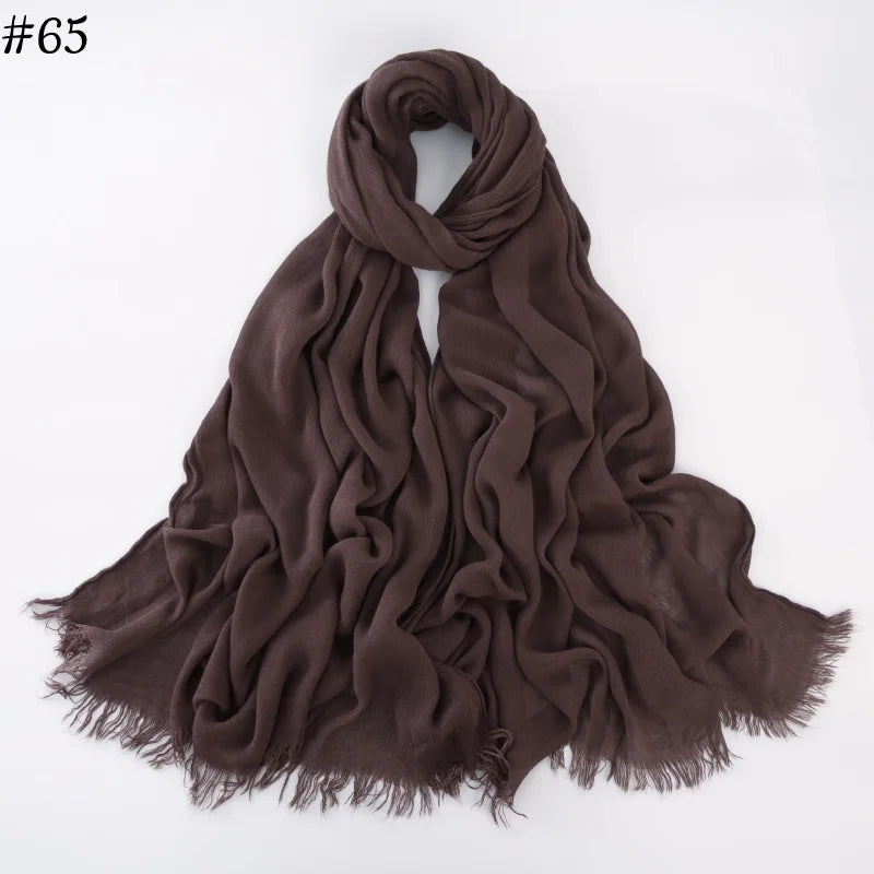 Foulard hijab en coton viscose brun foncé drapé sur fond blanc.