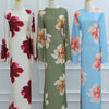 A full-length display of three luxury floral print abaya kaftan dresses in shades of green, pink, and blue.