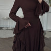 A dark brown elegant high-waisted long-sleeve A-line maxi dress shown on a model.