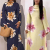 A model wearing a long navy blue abaya kaftan dress with a floral print and a model in a yellow dress with pink floral prints