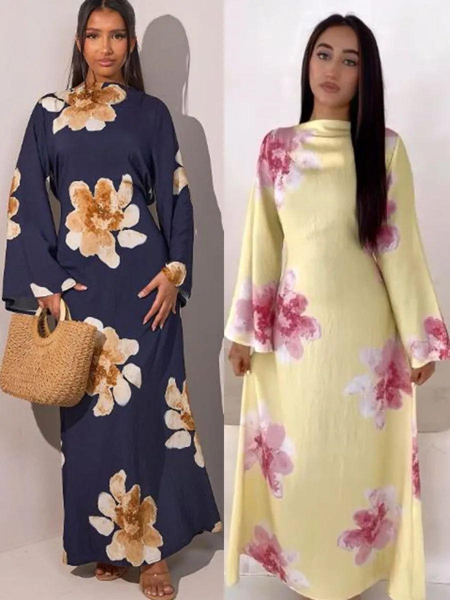 A model wearing a long navy blue abaya kaftan dress with a floral print and a model in a yellow dress with pink floral prints