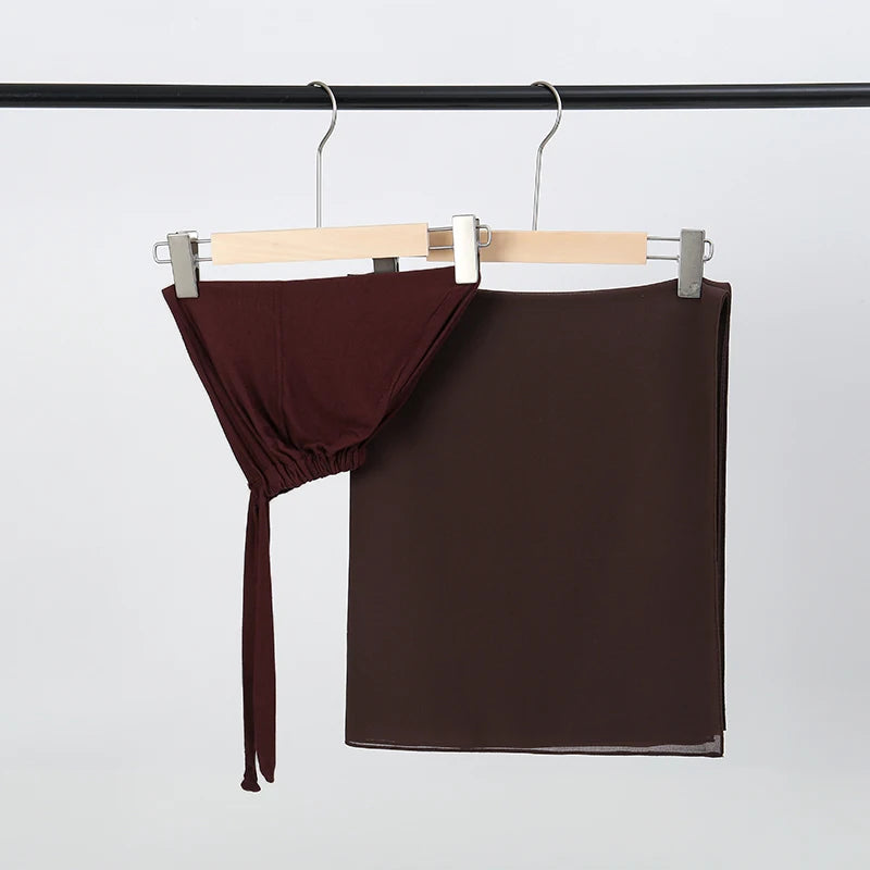 Dunkelbraunes Chiffon-Hijab und Untercap-Set an einem Holzhaken.