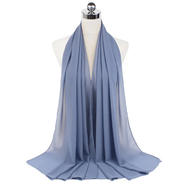 A light blue chiffon hijab scarf draped around a mannequin's neck.