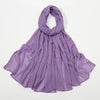 Écharpe châle en crêpe violet drapée et pliée élégamment.