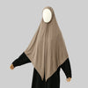 A beige large size stretchy modal square scarf worn over a black garment.