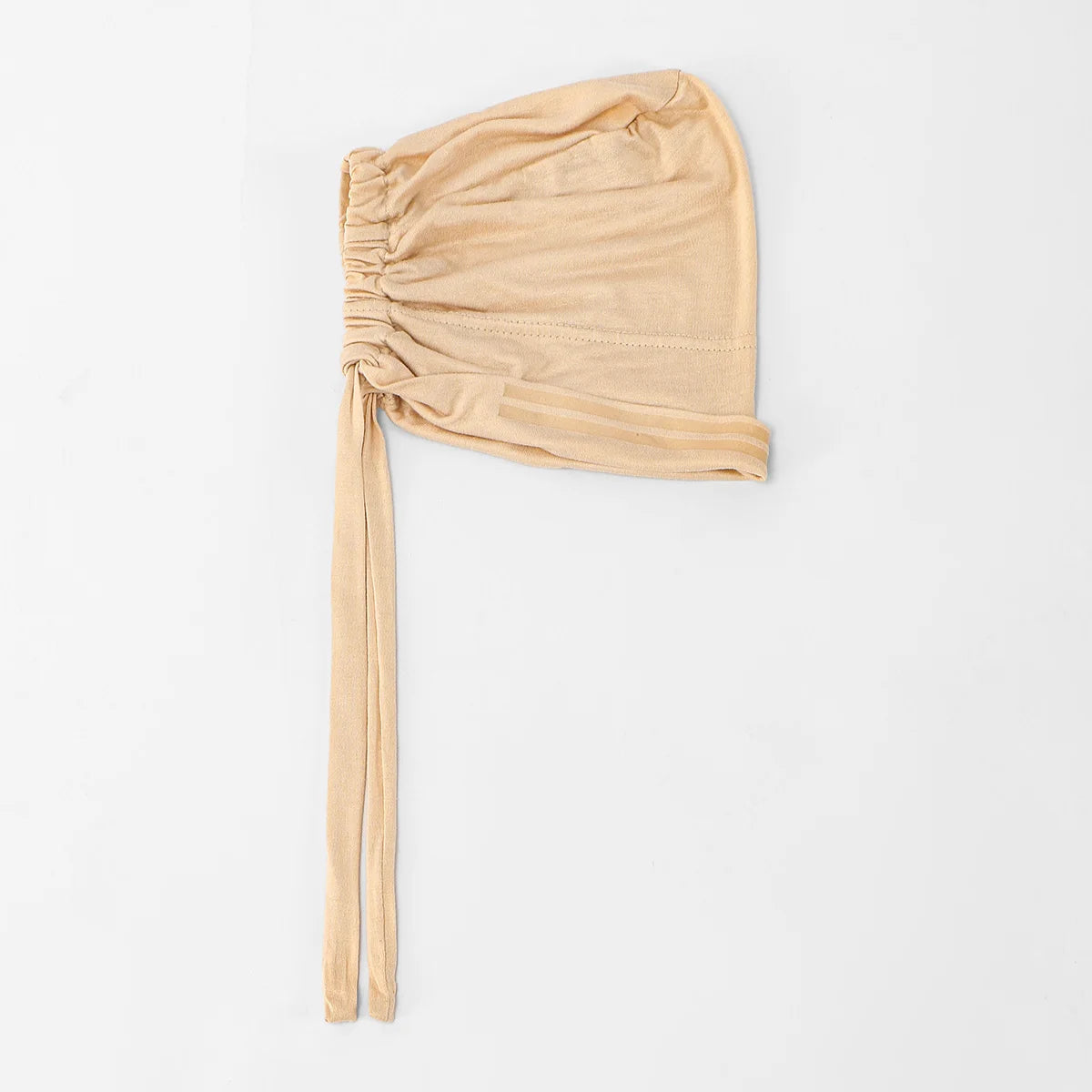 A beige elegant anti-slip inner hijab cap with gathered fabric and a long tie.
