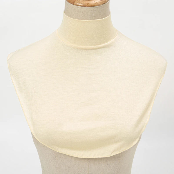 A cream-colored elegant modal turtleneck top displayed on a mannequin.