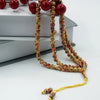 A string of 99 bead Islamic prayer tasbih for meditation and prayer, featuring wooden beads.