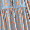 Light blue bohemian floral maxi dress featuring intricate patterns and lantern sleeves