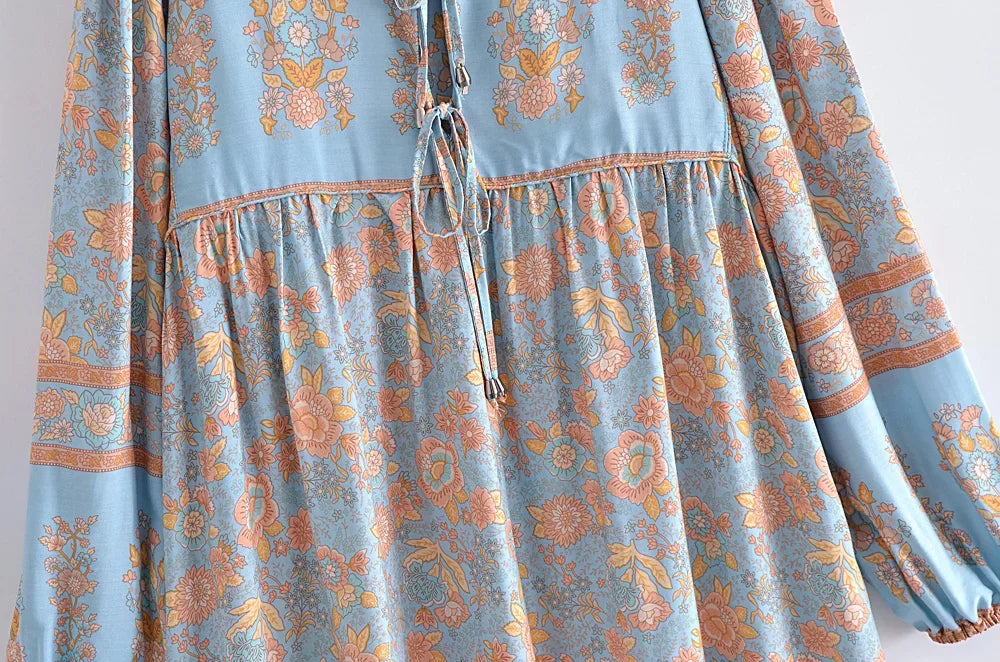Light blue bohemian floral maxi dress featuring intricate patterns and lantern sleeves