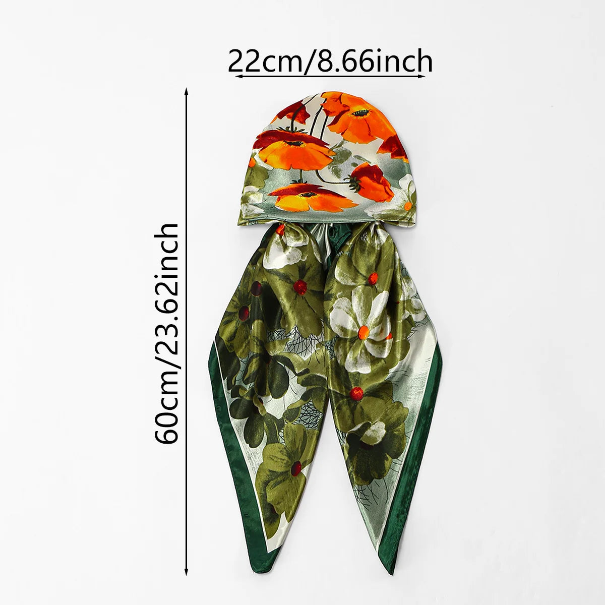 An orange and green floral satin silk instant hijab scarf displayed against a white background.