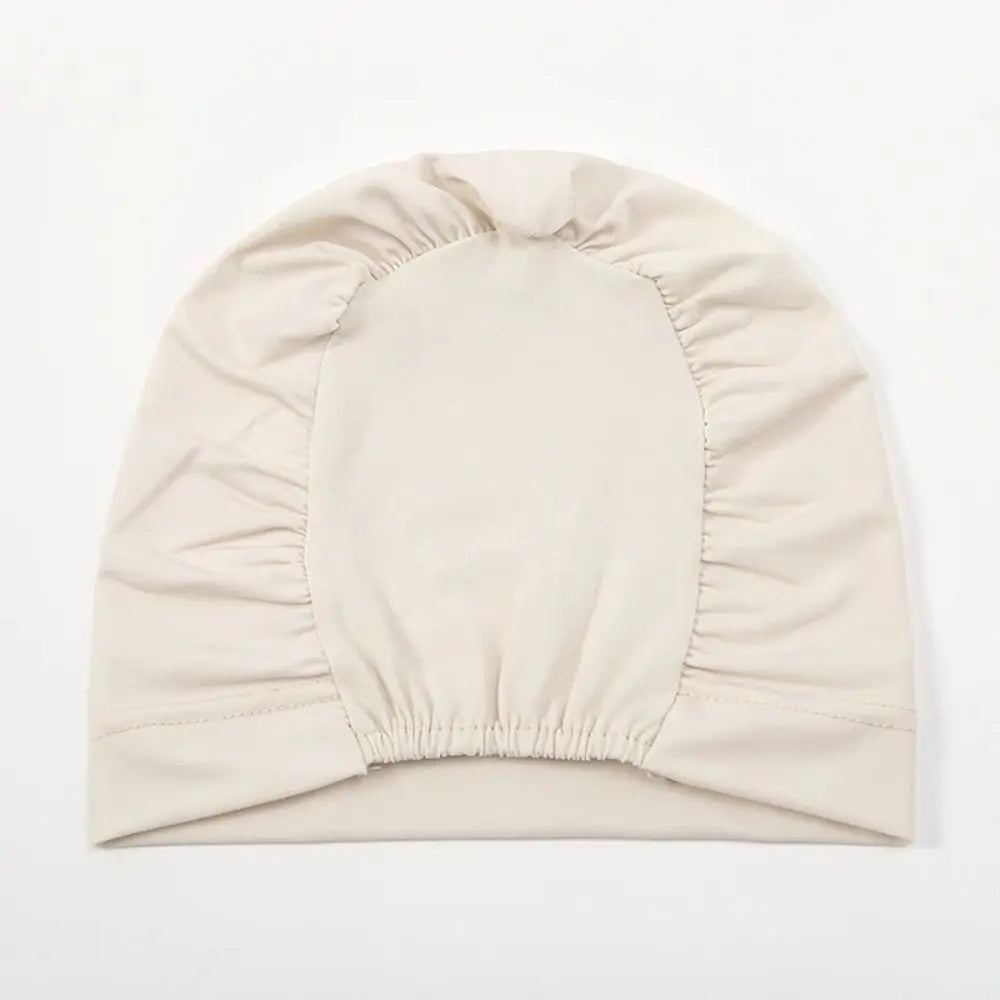 A beige breathable cotton underscarf with an elastic fit, shown flat.