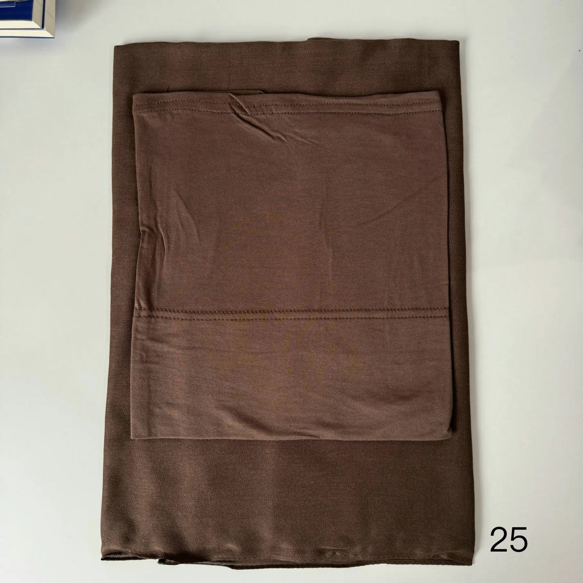 A dark brown soft modal rayon hijab set laid flat on a white surface.