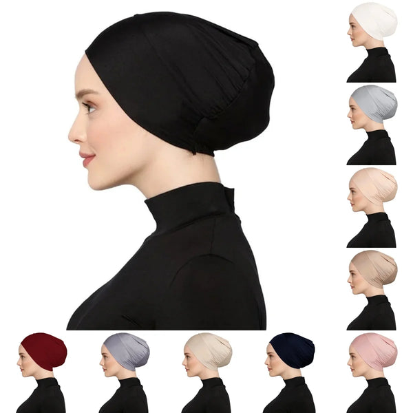 A set of instant turban hijabs in black, gray, beige, and navy shown on a model's head.