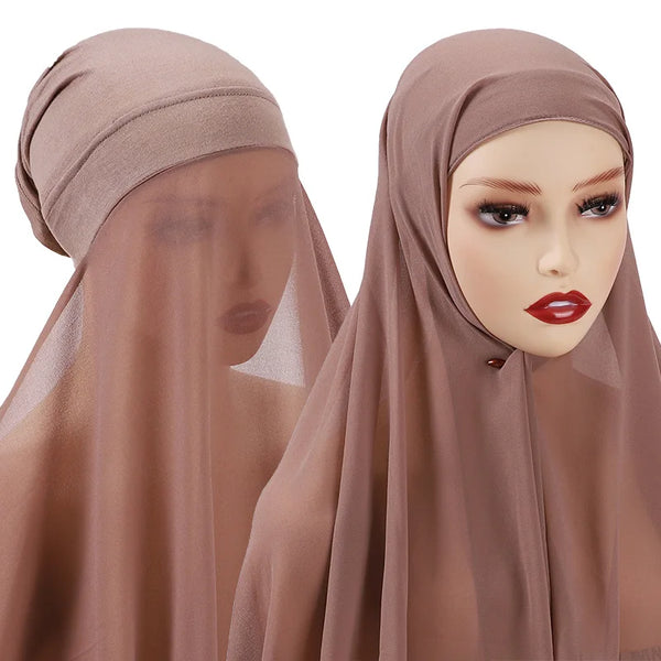 A close-up of a brown chiffon hijab and shawl set worn by a model.