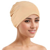A woman wearing a beige breathable cotton underscarf with an elastic fit