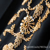 Close-up of gold floral beaded embroidery on black fabric for a luxury abaya set