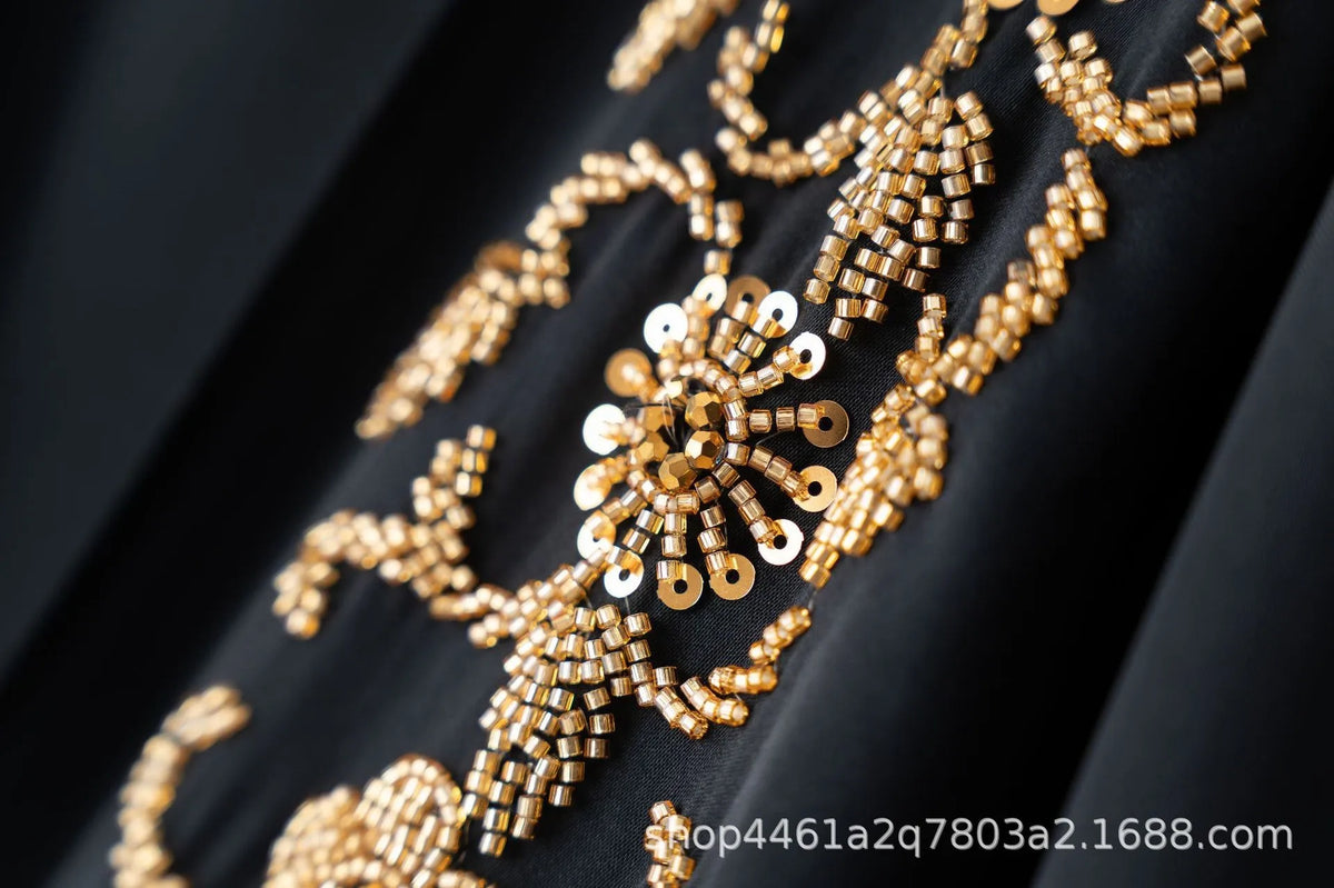Close-up of gold floral beaded embroidery on black fabric for a luxury abaya set
