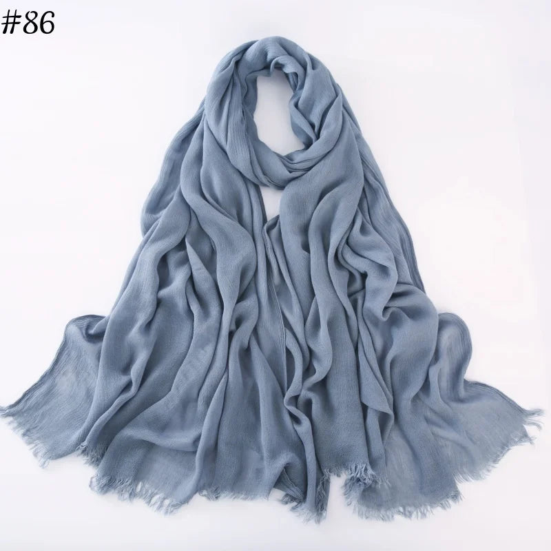 Foulard hijab viscose bleu gris doux drapé élégamment sur fond blanc.