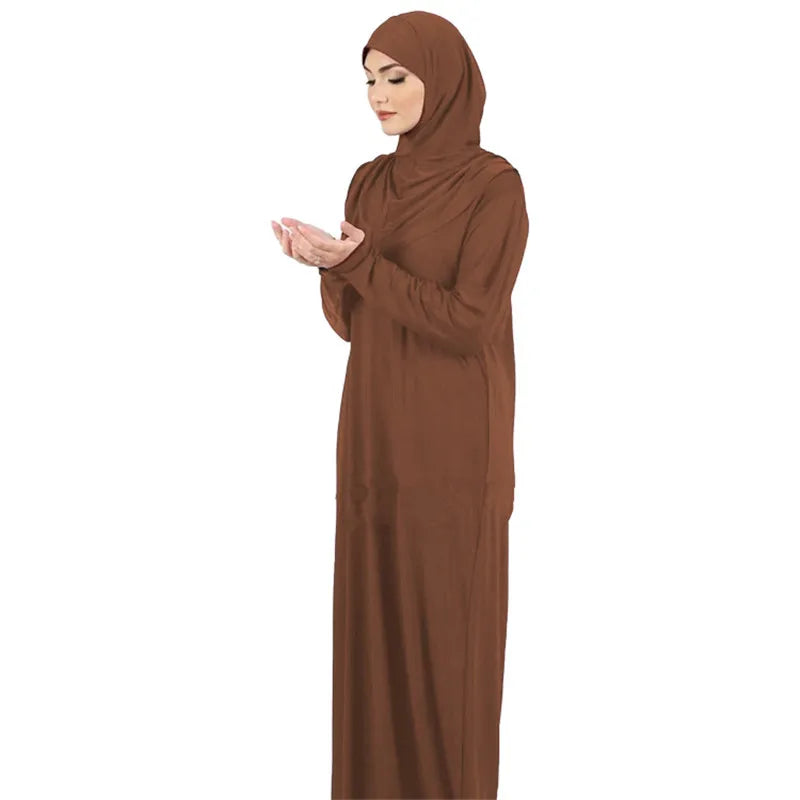 Una mujer vistiendo una elegante kaftan de abaya islámica marrón con hijab, vista de frente.